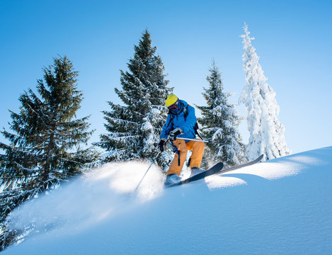 Shot of a professional freeride skier skiing in the mountains on a sunny winter day nature recreation active sportive hobby lifestyle sports concept
