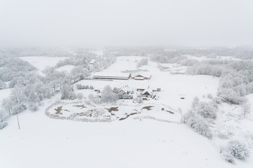 Aerial: Snow-covered countryside in winter