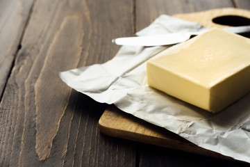 Pat of fresh farm butter with a knife
