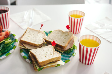 Delicious sandwiches with turkey and cheese for kids party. Beautifully decorated food