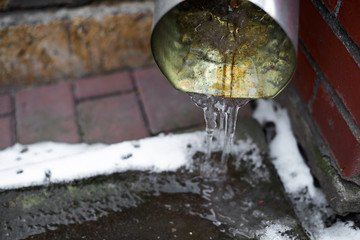 Naklejka na ściany i meble Ice in the drain on the street close, soft focus