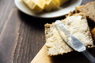 A knife spreading butter on bread