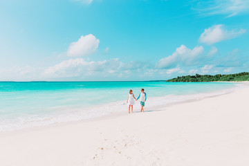 Fototapeta na wymiar happy loving couple walking on beach