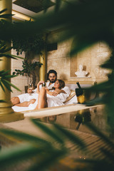 Beautiful young couple enjoying and relaxing in SPA center