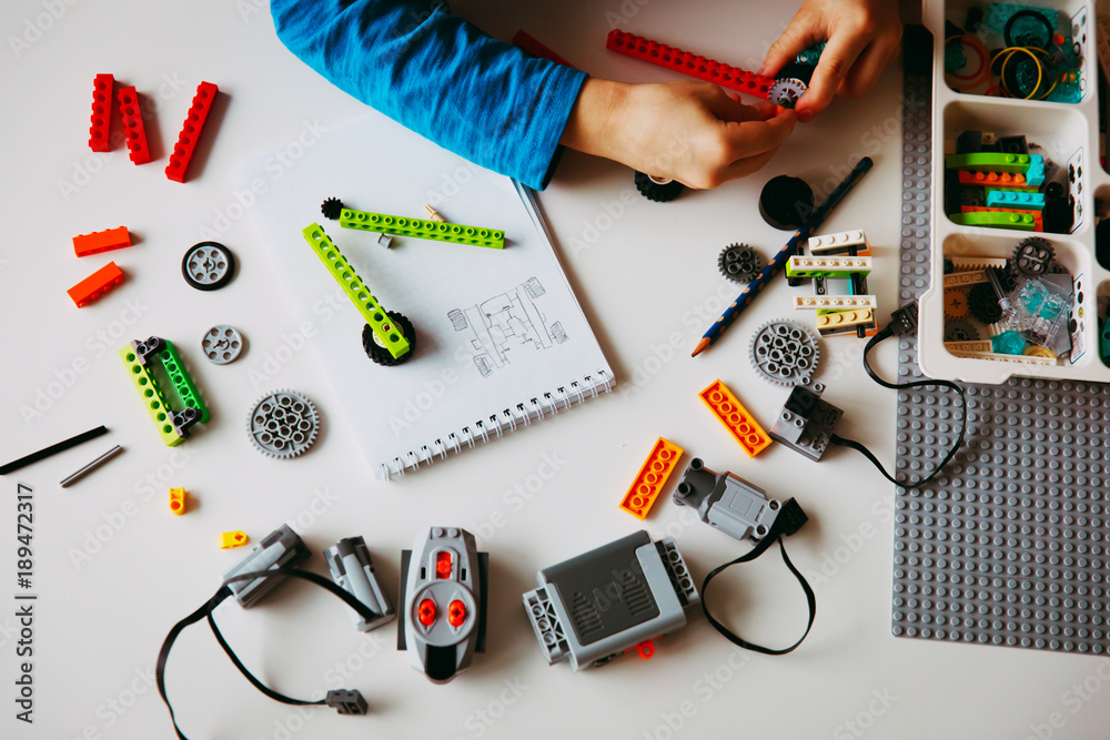 Wall mural child building robot at robotic technology school lesson