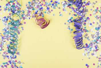 Background of yellow color, decorated celebration with confetti and balloons. Copyspace