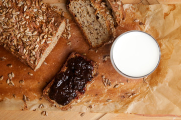 Homemade fresh baked bread with jam and glass of milk