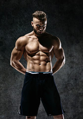 Fototapeta na wymiar Sporty muscular man shirtless. Photo of man with perfect body after training. Strength and motivation