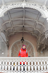 Woman tourist in red jacket at The Market Colonnade with its white structure in Karlovy Vary