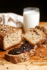 Homemade fresh baked bread with jam and glass of milk