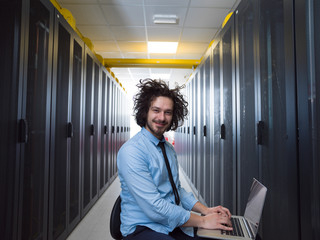 engineer working on a laptop in server room