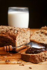 Homemade fresh baked bread with jam and glass of milk