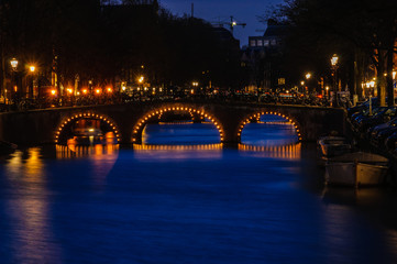 Fototapeta na wymiar Bridges at night in Canals of Amsterdam, Holland
