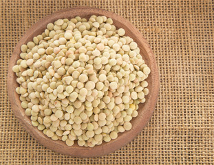 Raw lentils in the wooden bowl - Lens culinaris