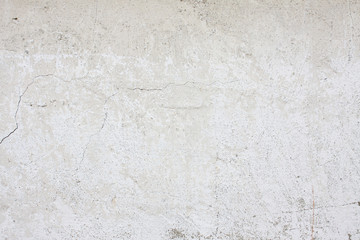old plaster wall with cracked plaster