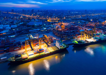 Aerial view of Containers yard in port congestion with ship vessels are loading and discharging...