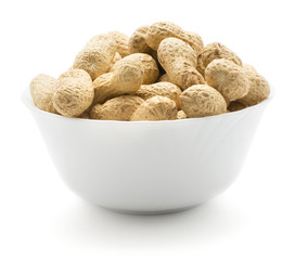 Unshelled raw peanuts in a porcelain bowl isolated on white background.