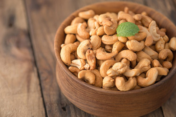 cashew nuts in wood bowl on old wood table