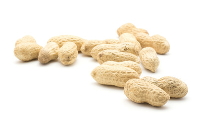 Unshelled peanuts stack isolated on white background.