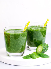 Fresh Tasty Spinach Cucumber Smoothie in Glasses Fresh Vgetables Detox Drink White Wooden Tray Gray Background Vertical