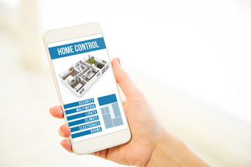 Woman holding a pink gold blank smartphone home control