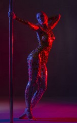 Nude pylon dancer with gold tape bodyart shot