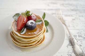 Pancakes with raspberries, strawberries and blueberries for Breakfast.