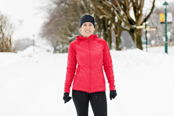 Blond woman running outdoors on a cold winter day