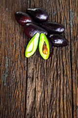 Avocado on rough wooden table. Selective focus.