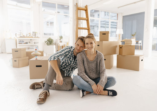 Portrait of smiling couple moving into new home