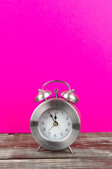 alarm clock with pink background and copy space