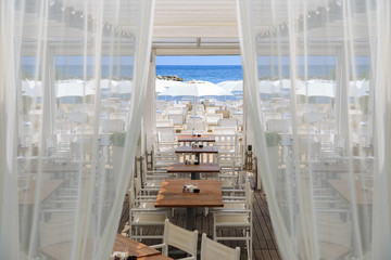 Romantic outdoor restaurant on resort at the seaside blue ocean.