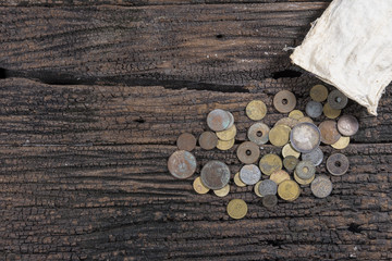 coins from various years on old wooden.