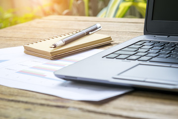 Workspace relaxing chill out work office with laptop book pen and document report on tablet in the garden
