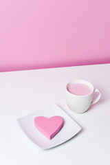 pink heart in a plate and cup of pink milkshake