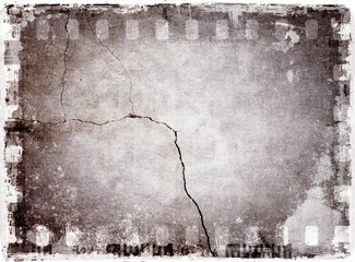 Grunge film strip frame with cracked wall. Black and white tones.