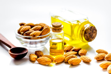 cosmetic and therapeutic almond oil on white background
