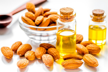 spa with almond oil in organic cosmetic set on white background