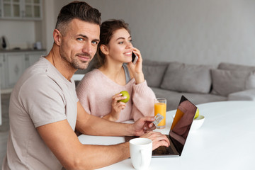 Portrait of a smiling young couple shopping online