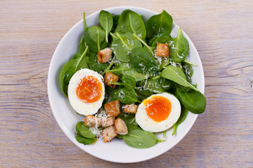 Boiled egg with toasted bread, spinach and parmesan cheese for breakfast. Breakfast meal. View from above, top, horizontal