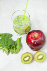 Energy for the whole day with fresh green smoothie with kiwi, banana, spinach and a juicy red apple.Top view. Healthy food, Diet, Fitness concept