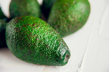Avocado on the green and white background. Top view