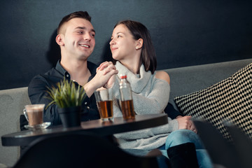 Young couple having fun at a caffe shop.