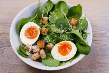 Boiled egg with toasted bread, spinach and parmesan cheese for breakfast. Breakfast meal, horizontal
