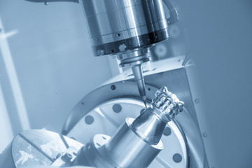 The 5-axis CNC machine cutting the sample part.The aero spaces part manufacturing process by 5-axis CNC machine. Modern manufacturing process.