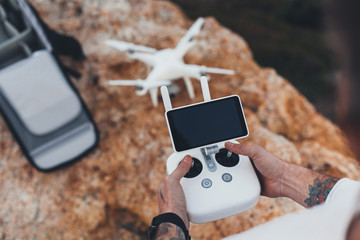Stock aerial video creator and photographer prepares drone for flight, sets up controls and remote connection, easy how to steps to learn drone instructions for amateurs and professionals