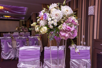 A wedding bouquet is on the table in the background of the hall. Bridal bouquet.