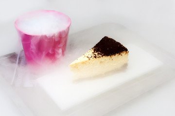 Cake on a white background, next to a bucket of nitrogen. Cake on a white background.