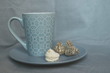 blue cup with drink and sweet candies 