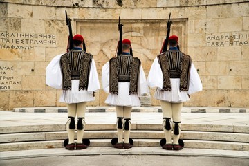 Greek Presidential Guard (evzone) in national clothes uniform at the tomb of unknown soldier in Athens, Greece. Ceremonial ritual changing guards.